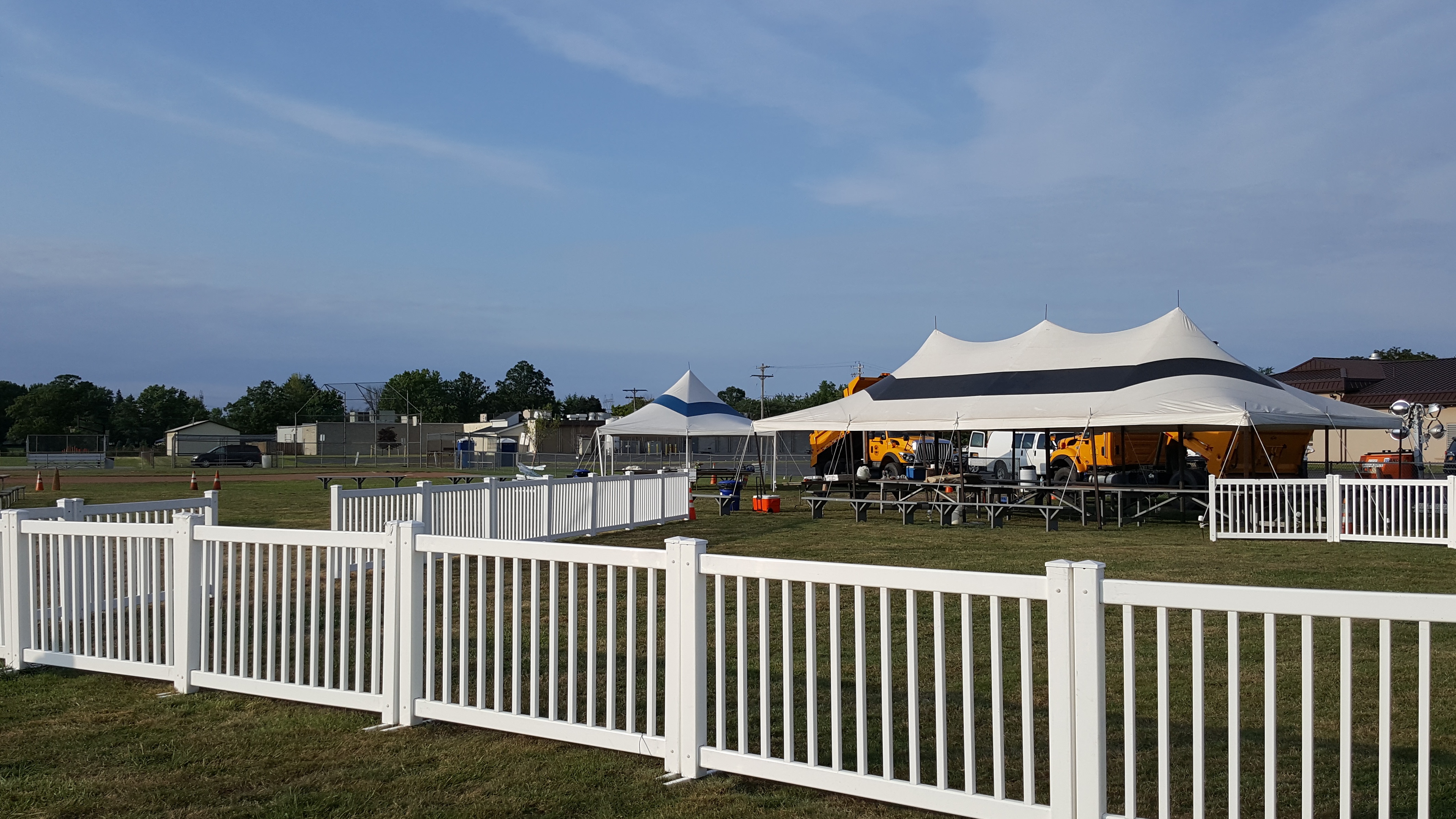 high-quality, white picket fence styled pedestrian fencing with event tent in background